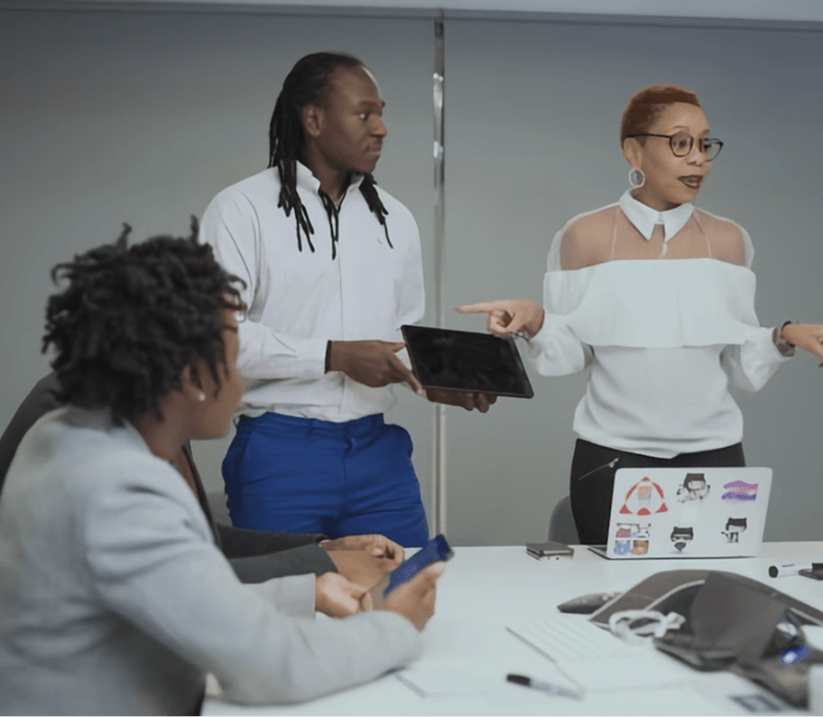 A team collaborating around a table with a tablet